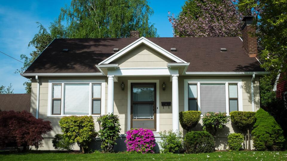 Single-family American craftsman house with blue sky background.