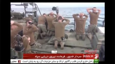 U.S. sailors are pictured on a boat with their hands on their heads at an unknown location in this still image taken from video taken January 12-13, 2016. REUTERS/IRINN via Reuters TV