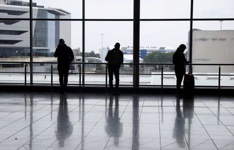 FILE PHOTO: Passengers wait to board international flights, amidst the spread of the new SARS-CoV-2 variant Omicron, at O.R. Tambo International Airport, in Johannesburg