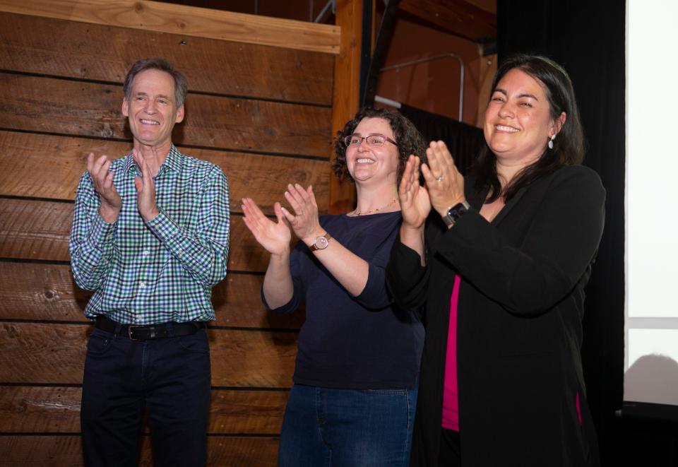 Eugene 4J school board candidates Tom Di Liberto, left, Morgan Munro and Jenny Jonak celebrate as early returns show them each winning their races during an election watch party at Whirled Pies in Eugene.
