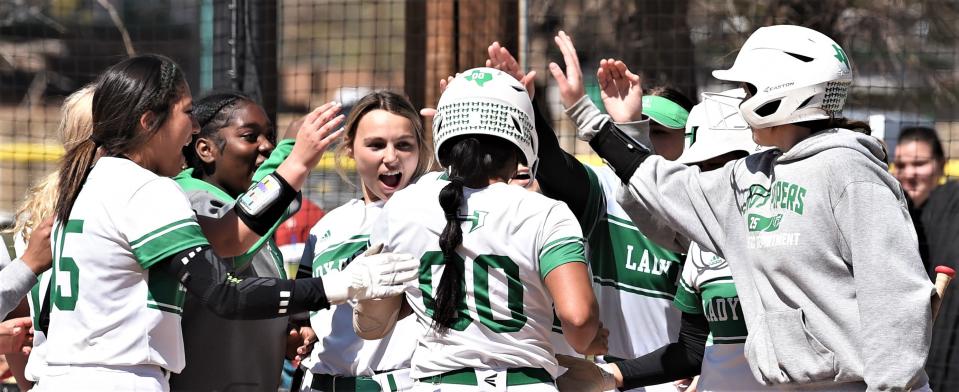 Hamlin players congratulate Samantha Williams (00) after her solo homer in the fourth gave the Lady Pipers a 10-2 lead over Haskell.