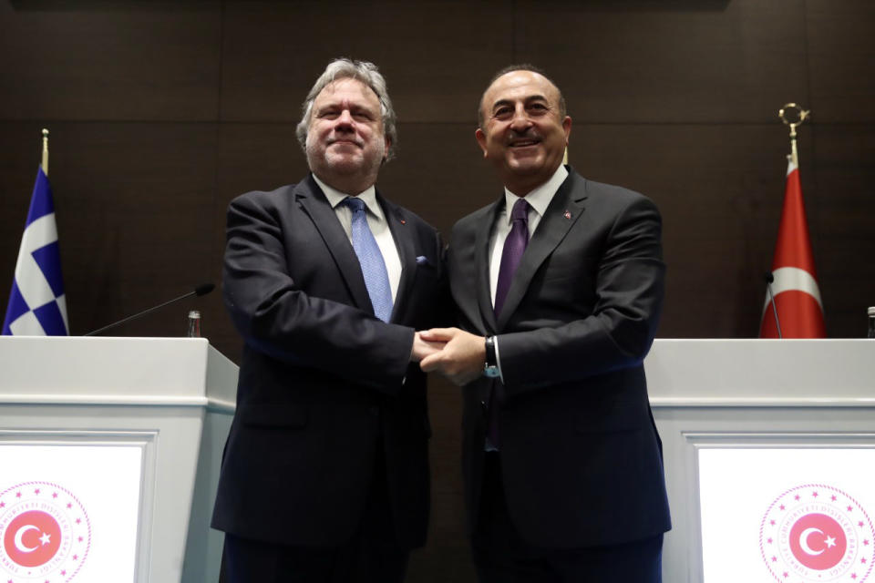 Turkey's Foreign Minister Mevlut Cavusoglu, right, and his Greek counterpart Giorgos Katrougalos pose for photos after a news conference in the Mediterranean coastal city of Antalya, Turkey, Thursday, March 21, 2019. Cavusogly says the defense chiefs of Turkey and Greece could meet soon as part of new confidence-building measures aimed at reducing tensions between the NATO allies. (Turkish Foreign Ministry via AP, Pool)