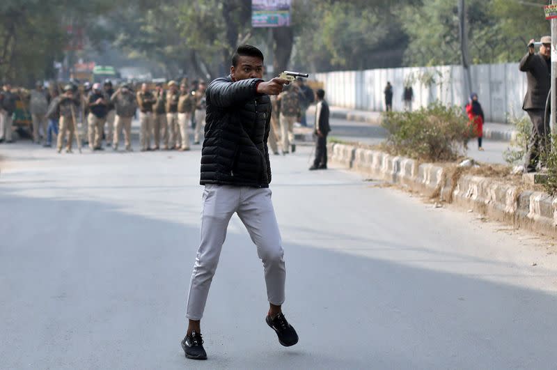Man brandishes a gun during a protest against a new citizenship law outside the Jamia Millia Islamia university in New Delhi