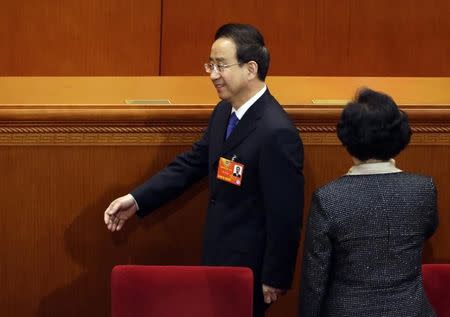 Ling Jihua (L), newly elected vice chairman of the Chinese People's Political Consultative Conference (CPPCC), leaves during a plenary meeting of the 12th CPPCC at the Great Hall of the People in Beijing March 11, 2013. REUTERS/Jason Lee