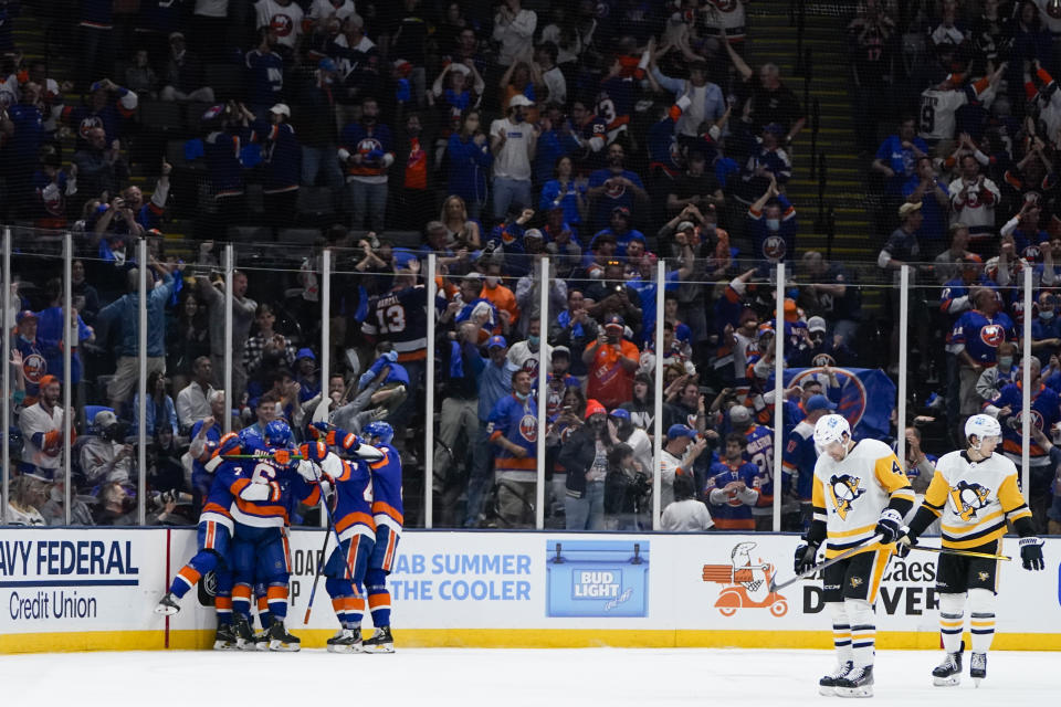 The New York Islanders celebrate a goal by Jordan Eberle during the third period of Game 4 of an NHL hockey Stanley Cup first-round playoff series against the Pittsburgh Penguins, Saturday, May 22, 2021, in Uniondale, N.Y. The Islanders won 4-1. (AP Photo/Frank Franklin II)