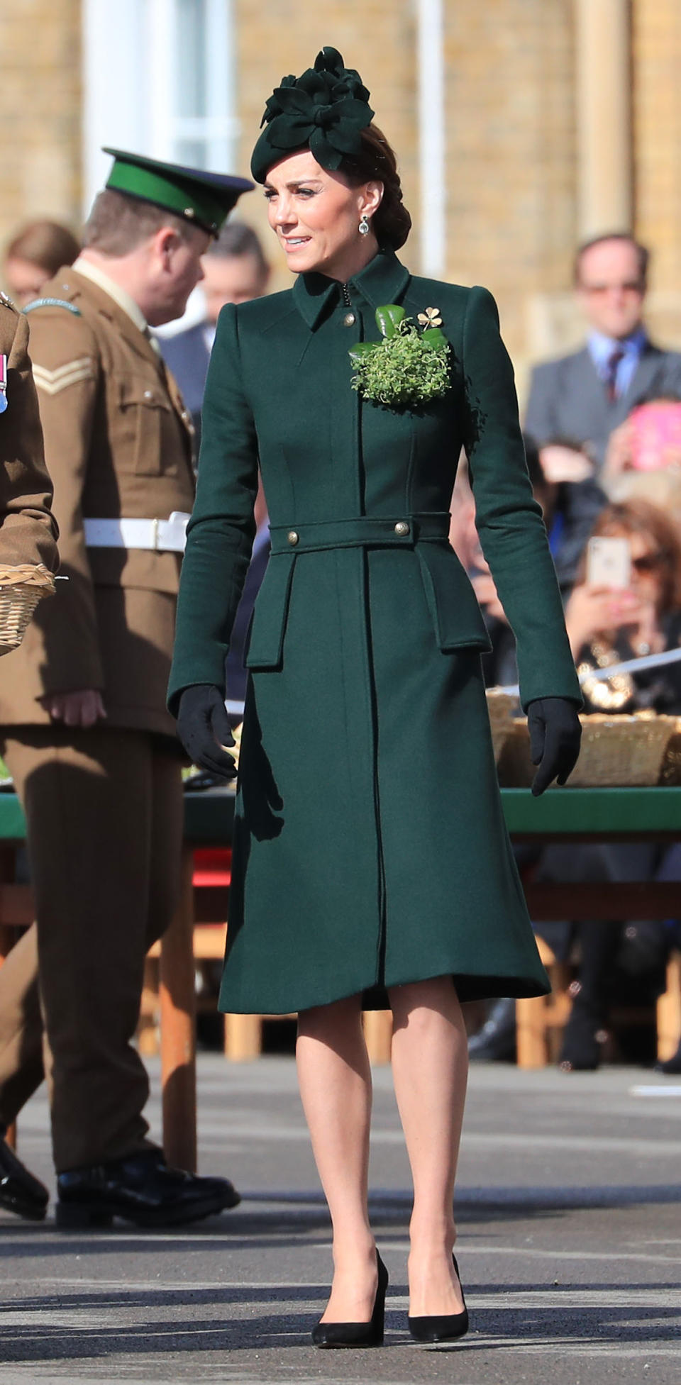 <p>Kate debuted a new custom military-style coat by Alexander McQueen, teaming with a matching hat and her Gianvito Rossi pumps. She accessorised with her Kiki McDonough tourmaline and amethyst earrings and the Cartier shamrock brooch.<em> [Photo: PA]</em> </p>