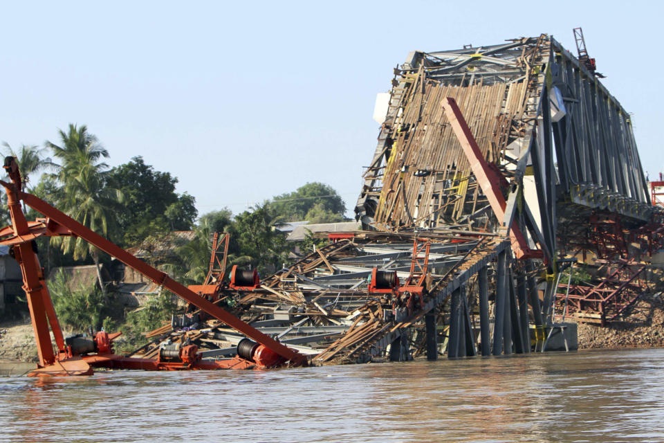 The Yadanatheinga Bridge which was under construction is seen collapsed into water in Irrawaddy River after it was damaged by a strong earthquake, Monday, Nov. 12, 2012, in Kyaukmyaung township in Shwebo, Sagaing Division, northwest of Mandalay, Myanmar. A strong earthquake collapsed a bridge and damaged ancient Buddhist pagodas in northern Myanmar, and piecemeal reports from the underdeveloped mining region said mines collapsed and as many as 12 people were feared dead. Myanmar's Vice President Sai Mauk Hkam visited the damaged sites Monday, while authorities resumed their search for four missing workers near the collapsed bridge. (AP Photo/Khin Maung Win)