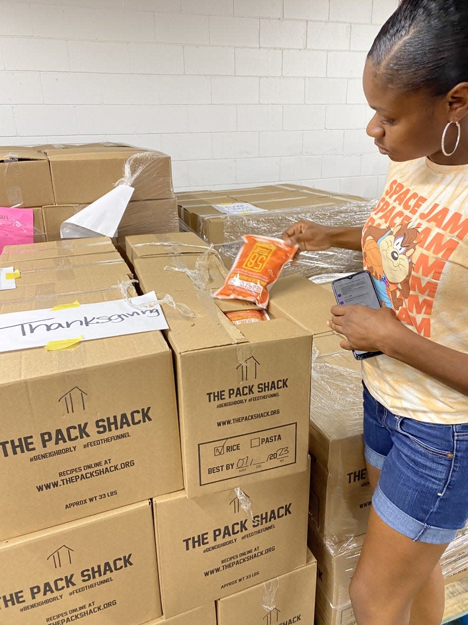 Dee Jones with Antioch shows some of the food that the organization will  give away.