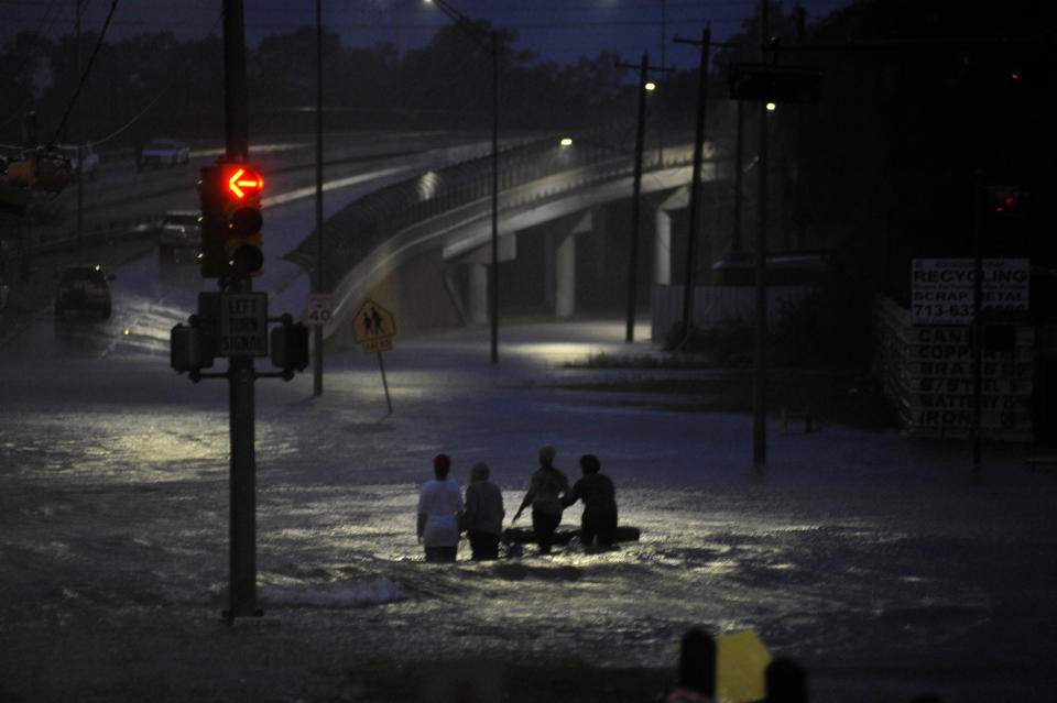 <p>Residents wade through floodwater after Hurricane Harvey inundated the Texas Gulf coast with rain causing widespread flooding, in Houston, Texas, Aug. 28, 2017. (Photo: Nick Oxford/Reuters) </p>