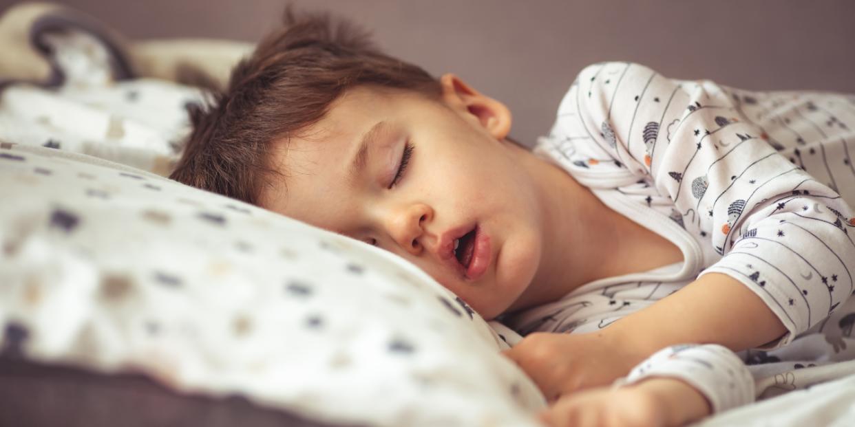 child in bed sleeping with mouth open pediatric sleep apnea