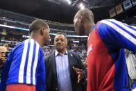 The Rev. Jesse Jackson, center, talks to Los Angeles Clippers' Chris Paul and Jamal Crawford before Game 5 of the Clippers' opening-round NBA basketball playoff series against the Golden State Warriors on Tuesday, April 29, 2014, in Los Angeles. NBA Commissioner Adam Silver announced Tuesday that Clippers owner Donald Sterling has been banned for life by the league. (AP Photo/Ringo H.W. Chiu)