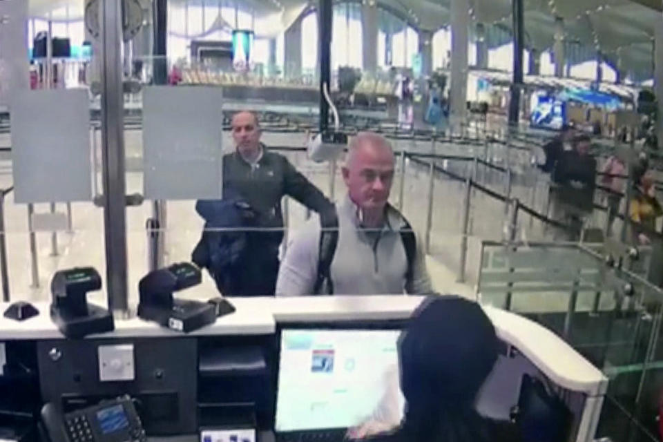 FILE—This Dec. 30, 2019 image from security camera video shows Michael L. Taylor, center, and George-Antoine Zayek at passport control at Istanbul Airport in Turkey. Japanese prosecutors have charged two Americans, Michael Taylor and his son Peter, in connection with the escape of former Nissan Chairman Carlos Ghosn to Lebanon. (DHA via AP, File)