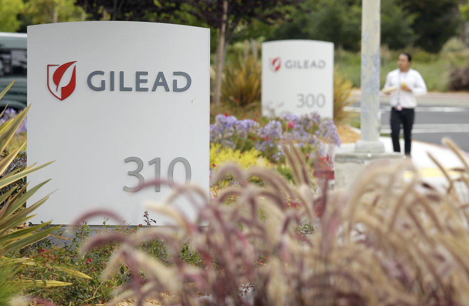 FILE - In this July 9, 2015, file photo, a man walks outside the headquarters of Gilead Sciences in Foster City, Calif. Gilead, the pharmaceutical giant that makes remdesivir, a promising coronavirus drug, has registered it as a rare disease treatment with U.S. regulators on Monday, March 23, 2020, a status that can potentially be worth millions in tax breaks and competition-free sales. (AP Photo/Eric Risberg, File)