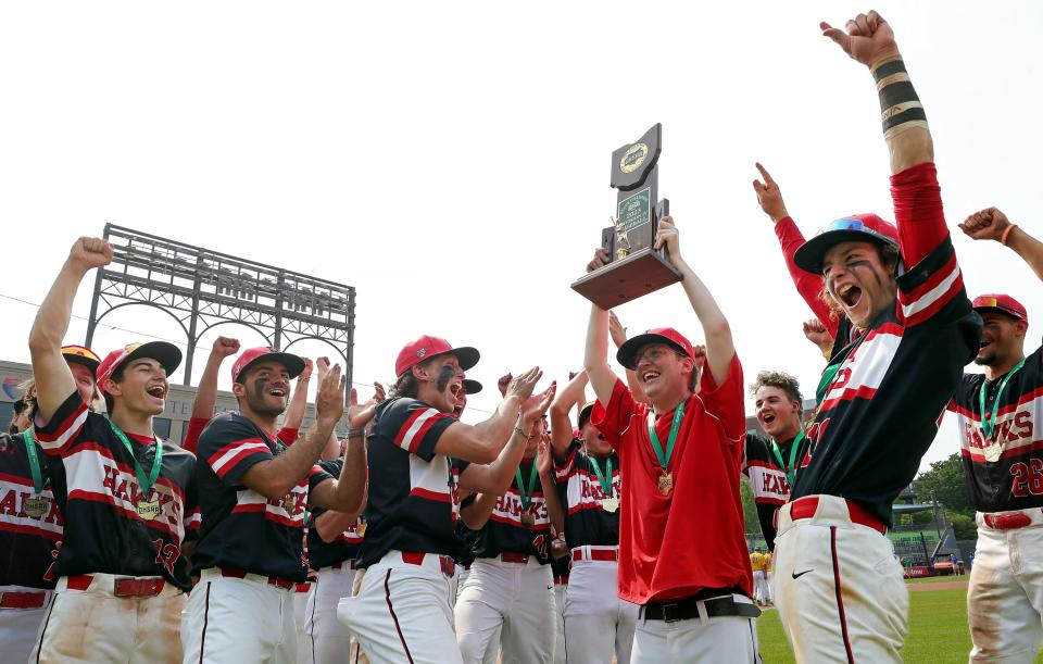 The Hiland Hawks celebrate with the OHSAA Division IV state championship trophy after beating Russia, 14-4, at Canal Park, Saturday, June 10, 2023, in Akron, Ohio.