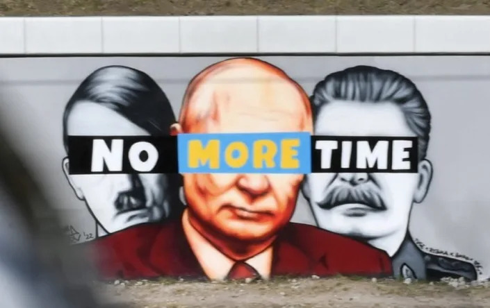 Murals showing Hitler, Putin and Stalin - ADAM WARZAWA/EPA-EFE/Shutterstock