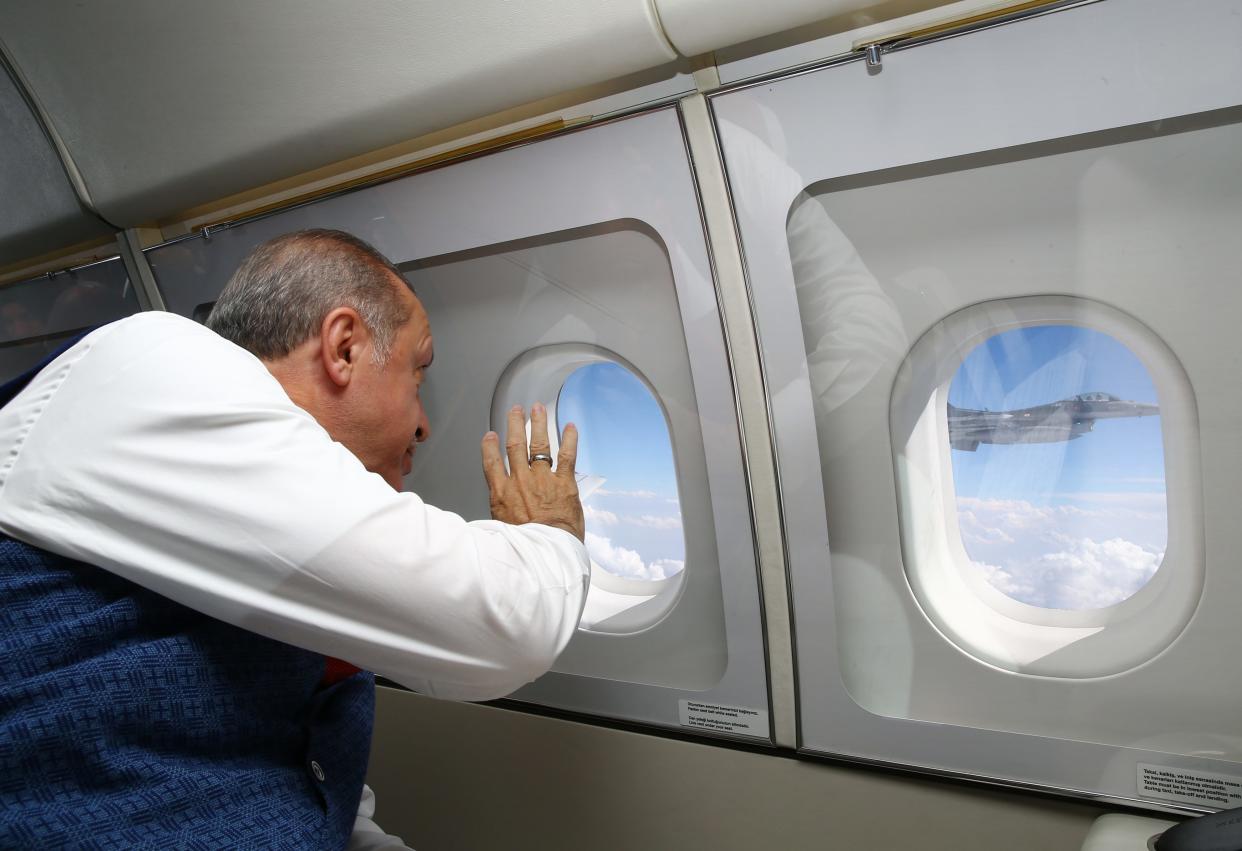 Turkey's President Recep Tayyip Erdogan from inside his airplane taking him from capital Ankara, Turkey to Istanbul - Presidency Pool/AP