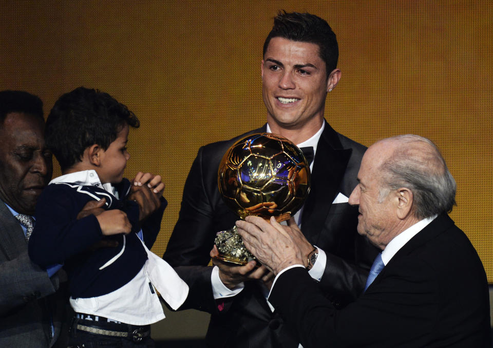 Cristiano Ronaldo of Portugal, center, is awarded the prize for the FIFA Men's soccer player of the year 2013 by FIFA President Sepp Blatter, right, at the FIFA Ballon d'Or 2013 gala at the Kongresshaus in Zurich, Switzerland, Monday, Jan. 13, 2014. (AP Photo, Keystone/Steffen Schmidt)