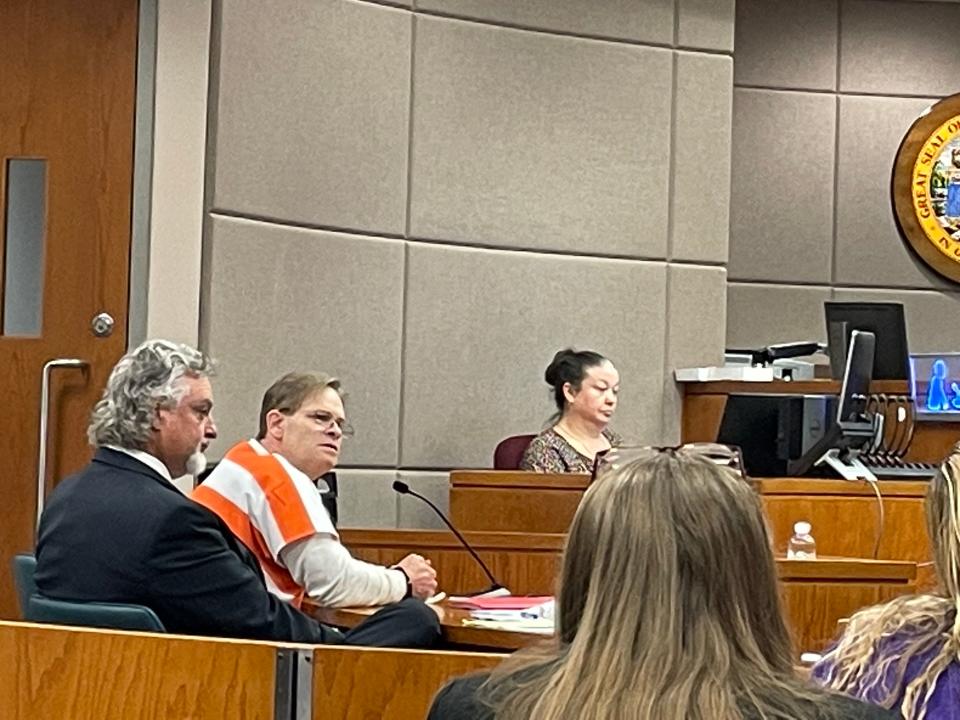 Stephen Douglas Lynn, in jail uniform, sits beside his lawyer, Bill Ramputi.