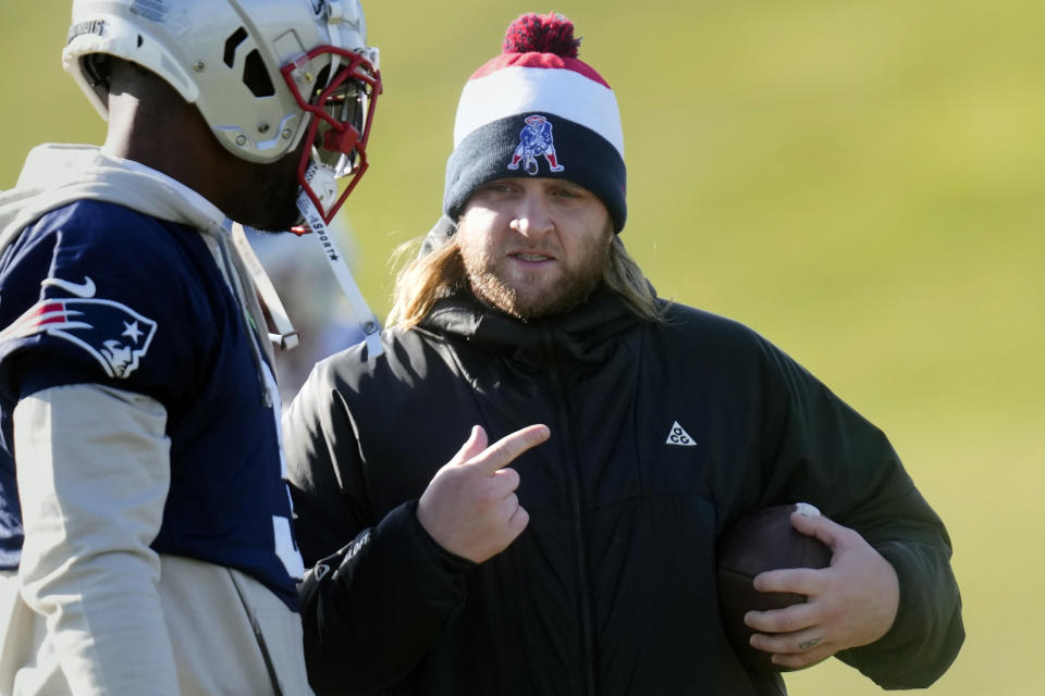 FILE - New England Patriots safeties coach Steve Belichick, right, talks with linebacker Mack Wilson Sr. during an NFL football practice, Wednesday, Jan. 3, 2024, in Foxborough, Mass. Steve Belichick has agreed to be the defensive coordinator for new coach Jedd Fisch at Washington, a person with knowledge of the move told The Associated Press on Monday, Feb. 5, 2024. The son of NFL coaching great Bill Belichick will take a role in college for the first time following 12 seasons working on the staff of the New England Patriots with his dad. (AP Photo/Charles Krupa, File)