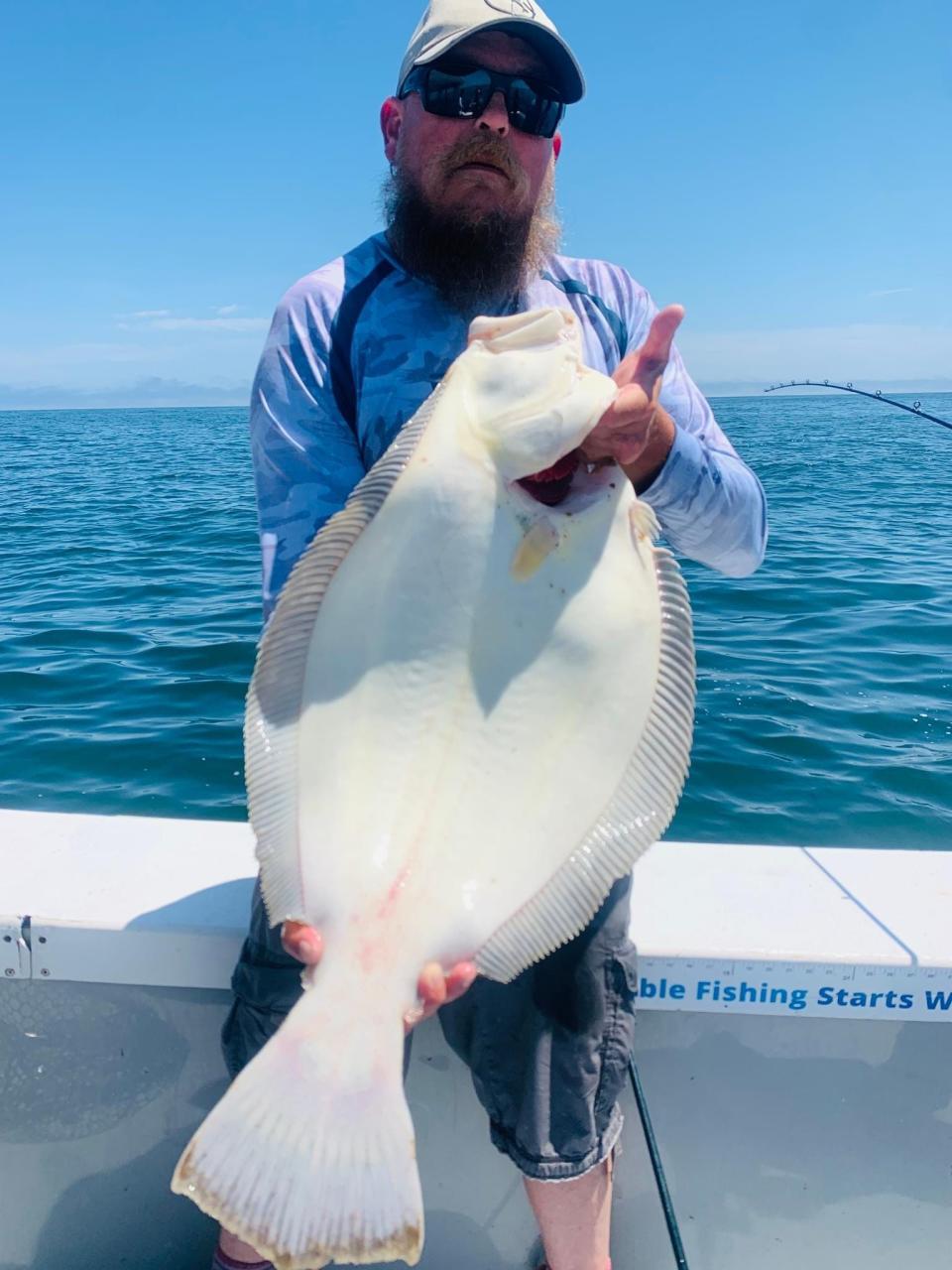 Mate Chris Gillis of JL Charters with a 30-inch summer flounder (fluke) caught off Point Judith, Narragansett.
