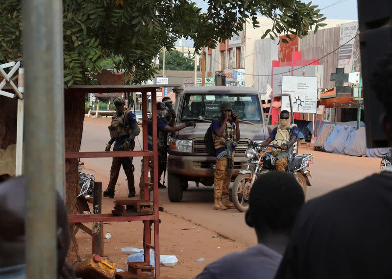 New junta's soldiers stand guard in a street of Ouagadougou