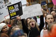 <p>Protestors carry placards and shout slogans during a demonstration calling for greater gun control outside the U.S. Embassy in south London on March 24, 2018. The London rally, in solidarity with the U.S. March For Our Lives rallies, is one of hundreds of gun control protests taking place globally. (Photo: Tolga Akmen/AFP/Getty Images) </p>