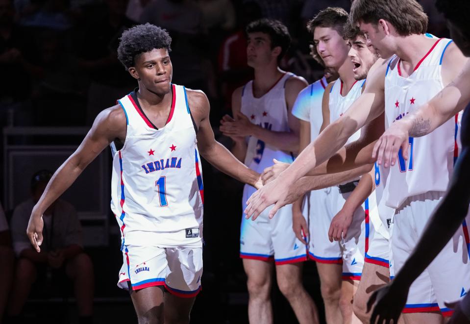 Indiana All-Star Markus Burton (1) high-fives his teammates before the start of the game Saturday, June 10, 2023, during the Indiana All-Stars game vs. Kentucky All-Stars at Gainbridge Fieldhouse in Indianapolis. 