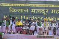 Activist Medha Patkar, center in white saree sits with other leaders as Indian farmers who have been protesting to demand guaranteed crop prices gather at Ramlila ground in New Delhi, India, Thursday, March 14, 2024. (AP Photo)