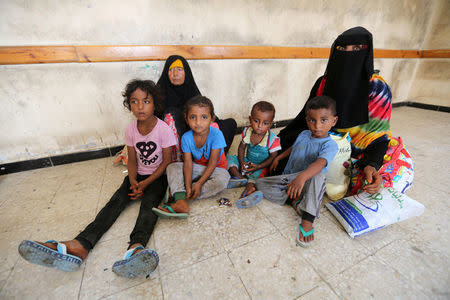 Family members sit in a classroom of a school to which they have been evacuated from a village near Hodeidah airport amid fighting between government forces and Houthi fighters in Hodeidah, Yemen June 17, 2018. REUTERS/Abduljabbar Zeyad