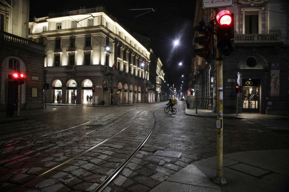 Streets are empty in Milan, northern Italy, early Sunday, Oct. 25, 2020. Since the 11 p.m.-5 a.m. curfew took effect last Thursday, people can only move around during those hours for reasons of work, health or necessity. (AP Photo/Luca Bruno)