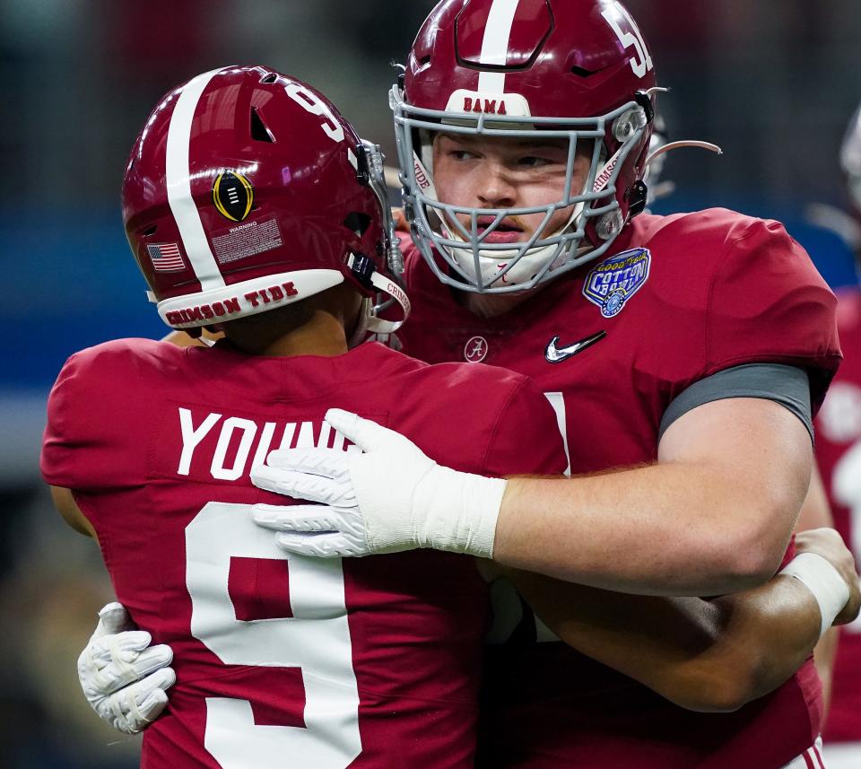 Alabama offensive lineman Tanner Bowles (51) hugs Alabama quarterback Bryce Young (9) during warm ups before the 2021 College Football Playoff Semifinal game at the 86th Cotton Bowl in AT&T Stadium in Arlington, Texas Friday, Dec. 31, 2021. [Staff Photo/Gary Cosby Jr.]