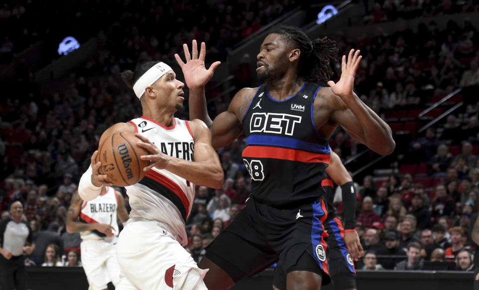 Portland Trail Blazers guard Josh Hart, left, drives to the basket on Detroit Pistons center Isaiah Stewart, right, during the first half of an NBA basketball game in Portland, Ore., Monday, Jan. 2, 2023. (AP Photo/Steve Dykes)