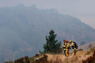 Firefighters survey a slope to look for hotspots during the Soberanes Fire in the mountains above Carmel Highlands, California, U.S. July 28, 2016. REUTERS/Michael Fiala