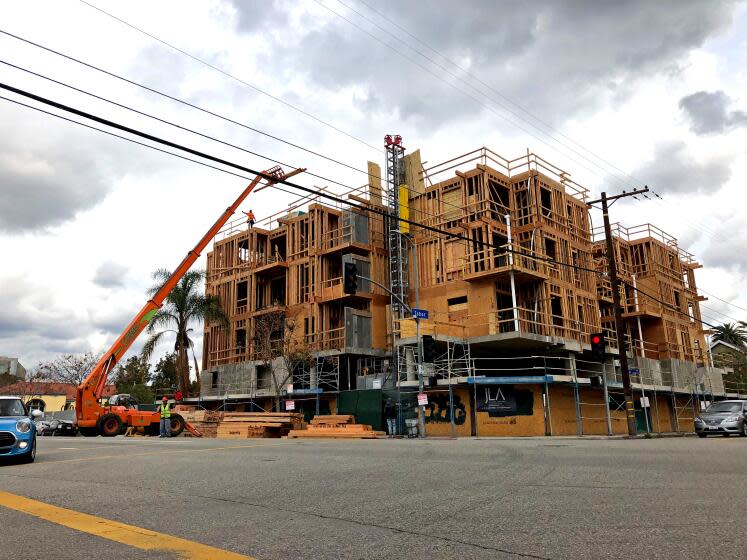 Construction workers on Friday, March 20, 2020, were busy building a new apartment building in the Palms neighborhood of Los Angeles. (Andrew Khouri / Los Angeles Times)