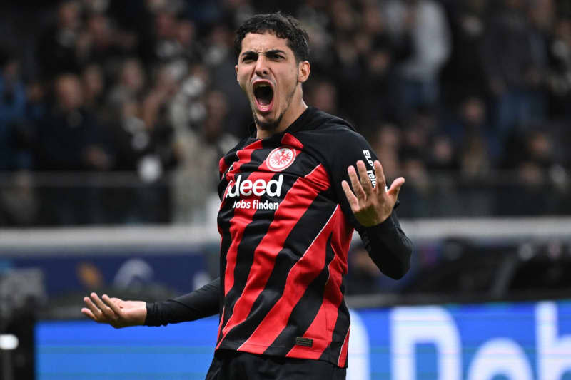 Frankfurt's Fares Chaibi celebrates scoring his side's first goal during the German Bundesliga soccer match between Eintracht Frankfurt and FC Augsburg at Deutsche Bank Park. Arne Dedert/dpa