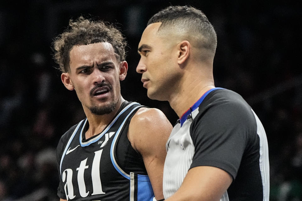 Atlanta Hawks guard Trae Young (11) speaks to an offical during the second half of an NBA basketball game between the Atlanta Hawks and the Memphis Grizzlies, Saturday, Dec. 23, 2023, in Atlanta. (AP Photo/Mike Stewart)