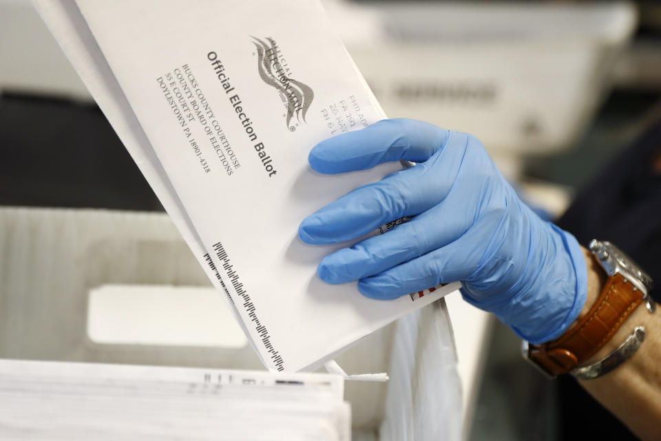 A worker processes mail-in ballots at the Bucks County Board of Elections office prior to the primary election on May 27, 2020 in Doylestown, Pa. (Matt Slocum/AP)