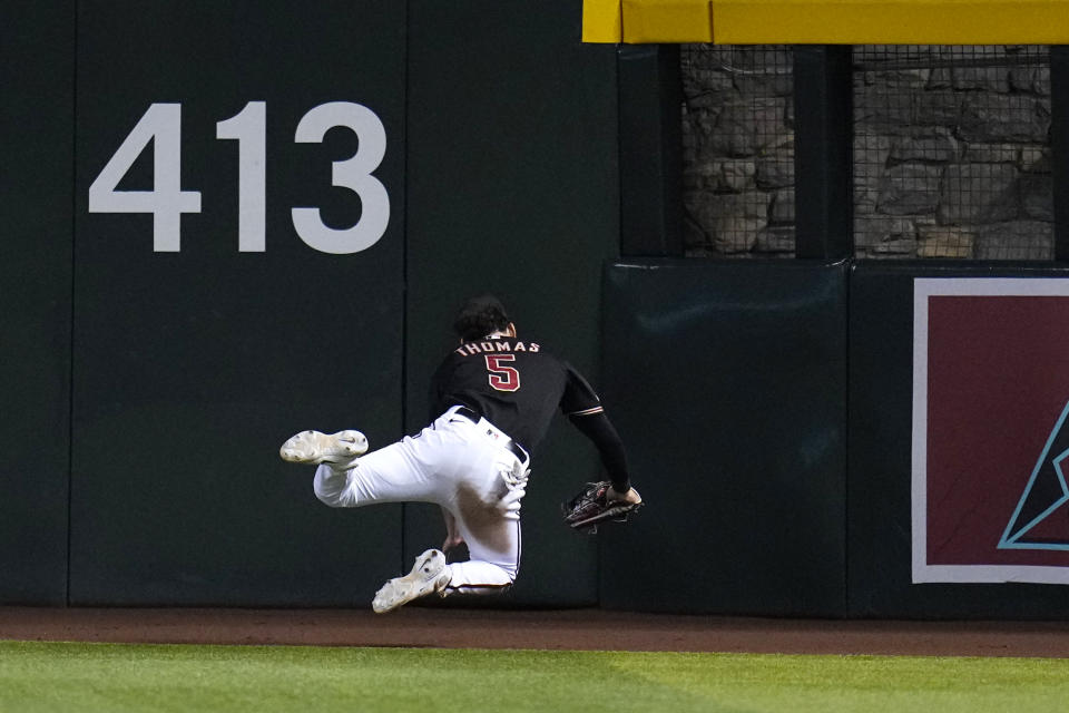 Arizona Diamondbacks center fielder Alek Thomas makes a diving catch of a fly ball hit by Texas Rangers' Marcus Semien during the ninth inning of a baseball game Tuesday, Aug. 22, 2023, in Phoenix. The Diamondbacks won 6-3. (AP Photo/Ross D. Franklin)