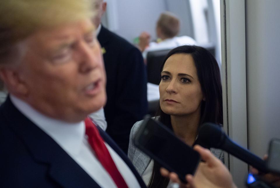 White House press secretary Stephanie Grisham listens as President Trump speaks to the media aboard Air Force One, Aug. 7, 2019. (Photo by Saul Loeb/AFP via Getty Images)