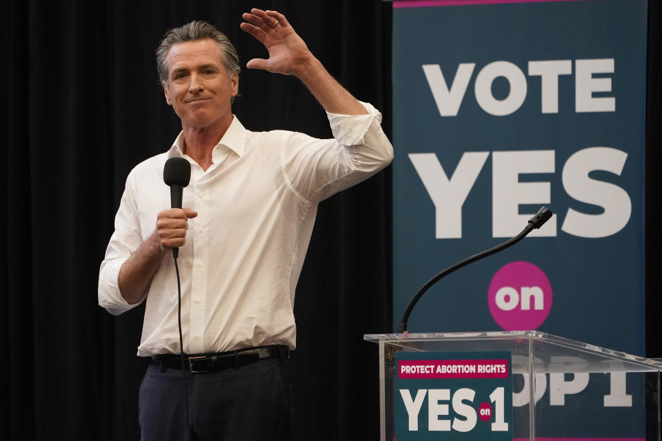 FILE - California Governor Gavin Newsom urges voters to turn out and vote YES on Proposition 1 at a rally at Long Beach City College in Long Beach, Calif., Sunday, Nov. 6, 2022. A variety of new laws take effect Sunday, Jan. 1, 2023 that could have an impact on people's finances and, in some cases, their personal liberties. (AP Photo/Damian Dovarganes, File)