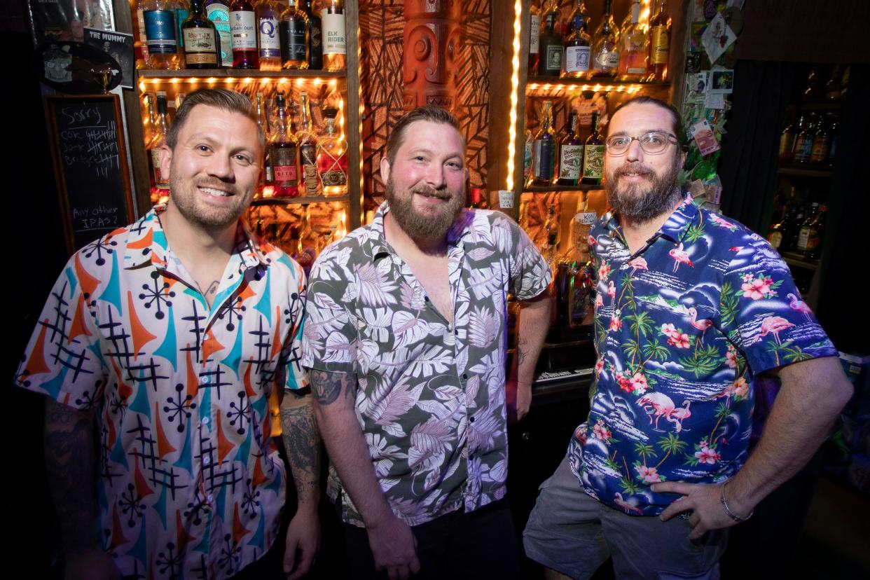 Jameson Cowman, left, Teren Baker and Scott Mapa co-own Monkey’s Paw Tiki Bar on Main Street in Springfield.