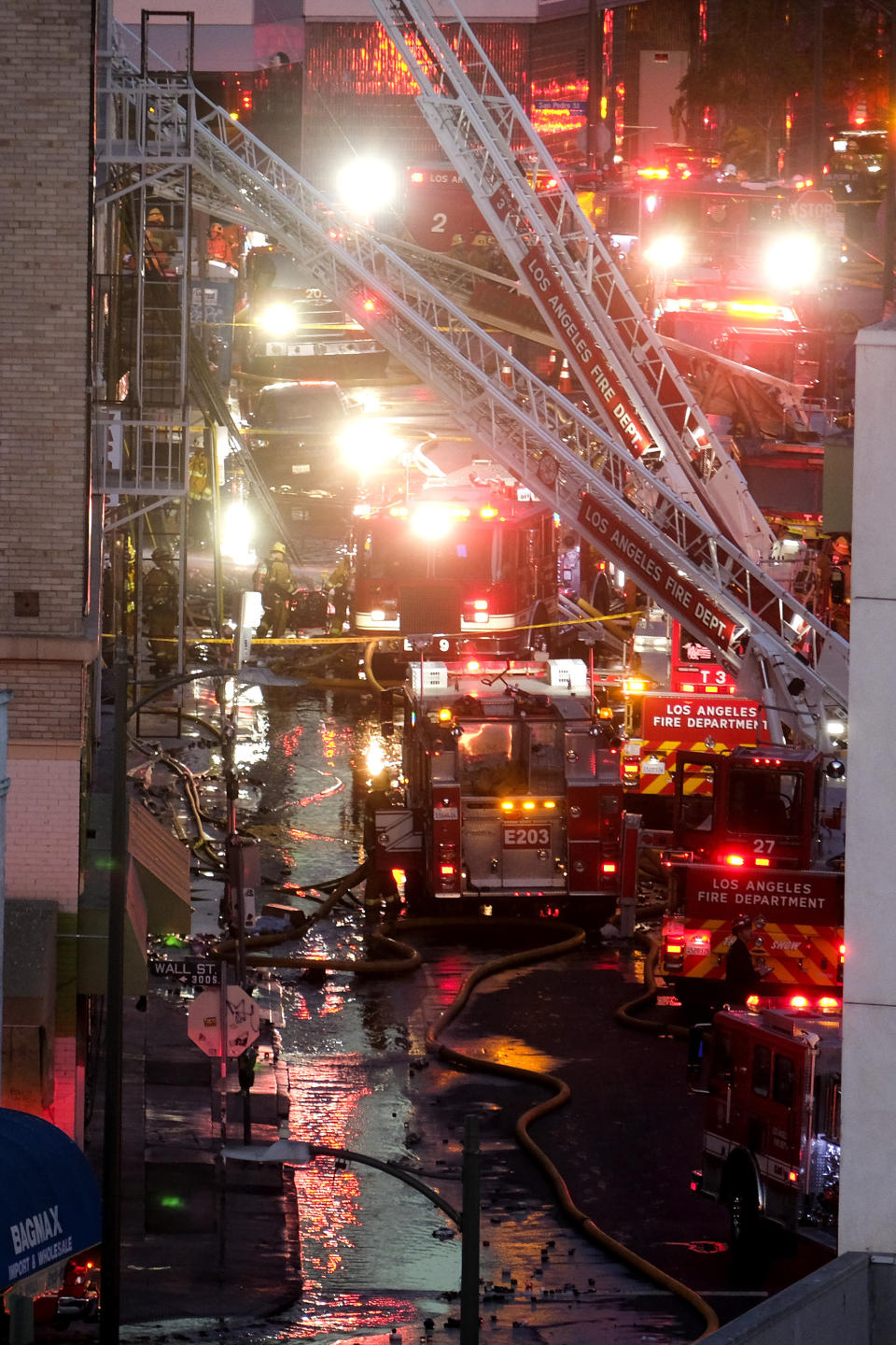 Los Angeles Fire Department firefighters work the scene of a structure fire that injured multiple firefighters, according to a fire department spokesman, Saturday, May 16, 2020, in Los Angeles. (AP Photo/Ringo H.W. Chiu)