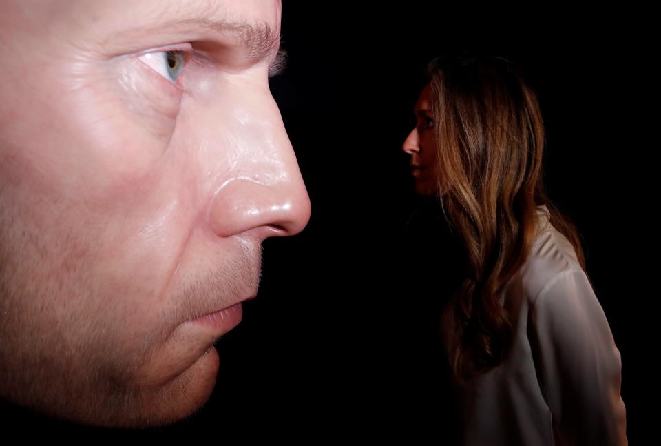 A gallery assistant poses by a sculpture entitled 'Dark Place' by Australian artist Ron Mueck displayed at Thaddaeus Ropac gallery in London, Britain, October 11, 2021.