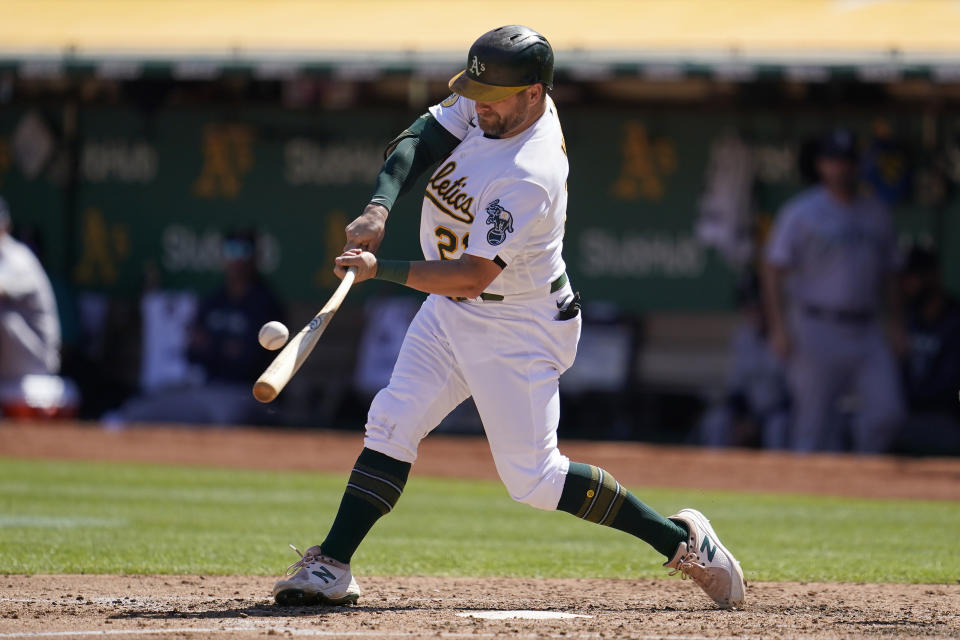 Oakland Athletics' Stephen Vogt hits a three run-triple against the Seattle Mariners during the third inning of a baseball game in Oakland, Calif., Thursday, Sept. 22, 2022. (AP Photo/Jeff Chiu)