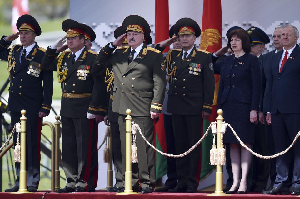 Belarusian President Alexander Lukashenko, center, salutes as he watches a military parade that marked the 75th anniversary of the allied victory over Nazi Germany, in Minsk, Belarus, Saturday, May 9, 2020. (Sergei Gapon/Pool via AP)