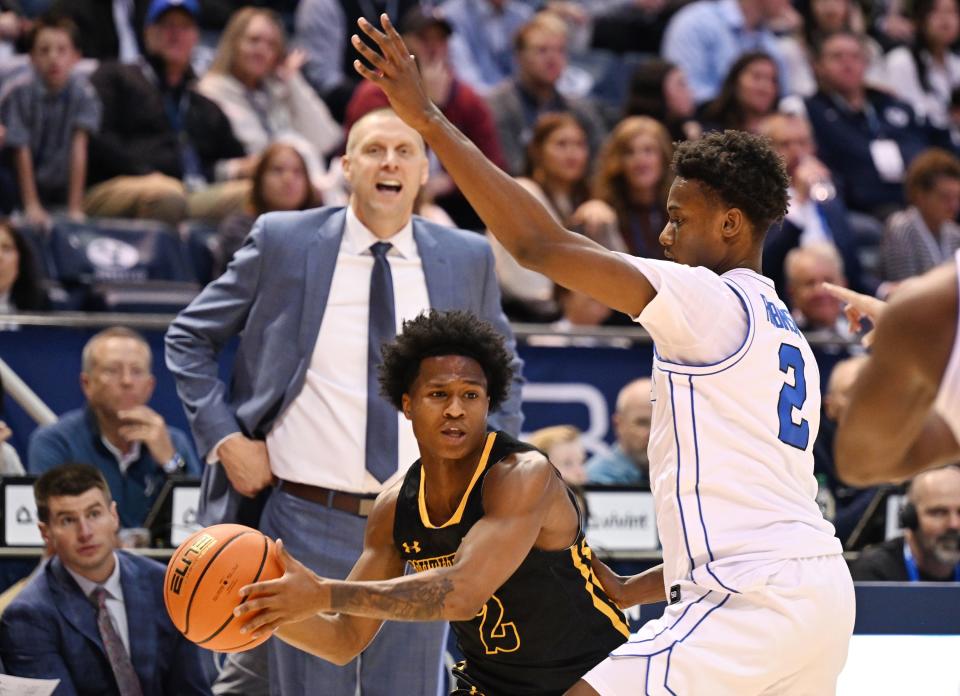 Brigham Young Cougars guard Jaxson Robinson (2) defends Southeastern Louisiana Lions guard Roscoe Eastmond (2) as Brigham Young Cougars head coach Mark Pope watches from the sidelines as BYU and SE Louisiana play at the Marriott Center in Provo on Wednesday, Nov. 15, 2023. | Scott G Winterton, Deseret News