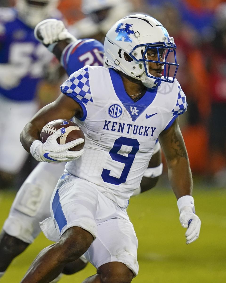 Kentucky wide receiver Tayvion Robinson (9) runs past Florida defensive lineman Justus Boone during the second half of an NCAA college football game, Saturday, Sept. 10, 2022, in Gainesville, Fla. (AP Photo/John Raoux)