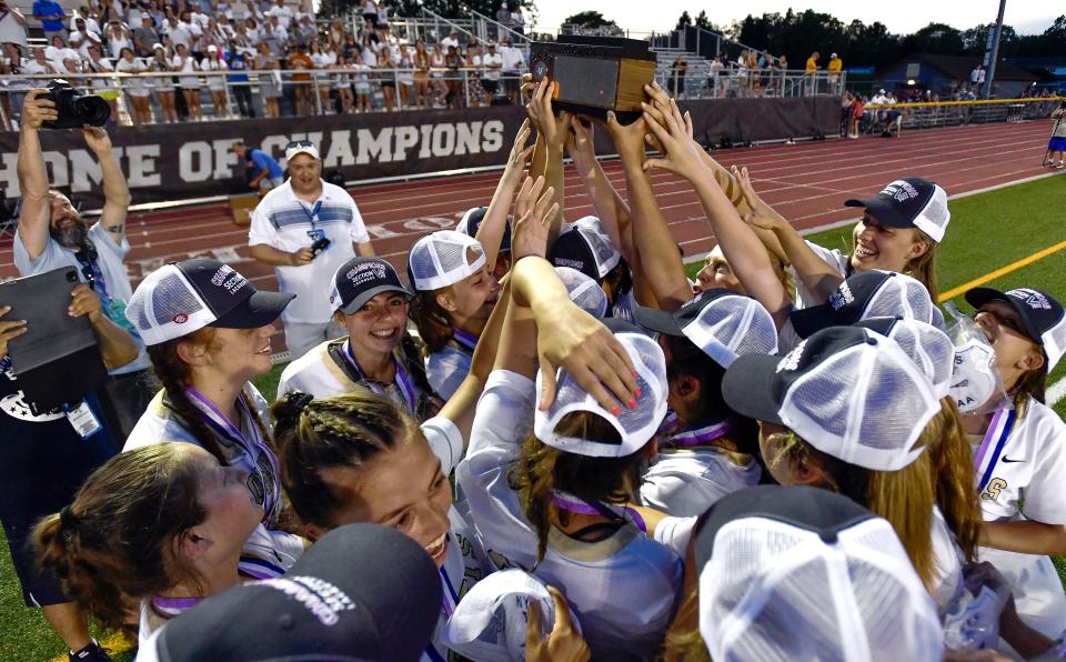 Rush-Henrietta players hoist the championship block after the Section V Class A Championship at East Rochester High School, Tuesday, May 31, 2022. No. 1 seed Rush-Henrietta claimed the Class A title with a 9-3 win over No. 2 seed Pittsford.