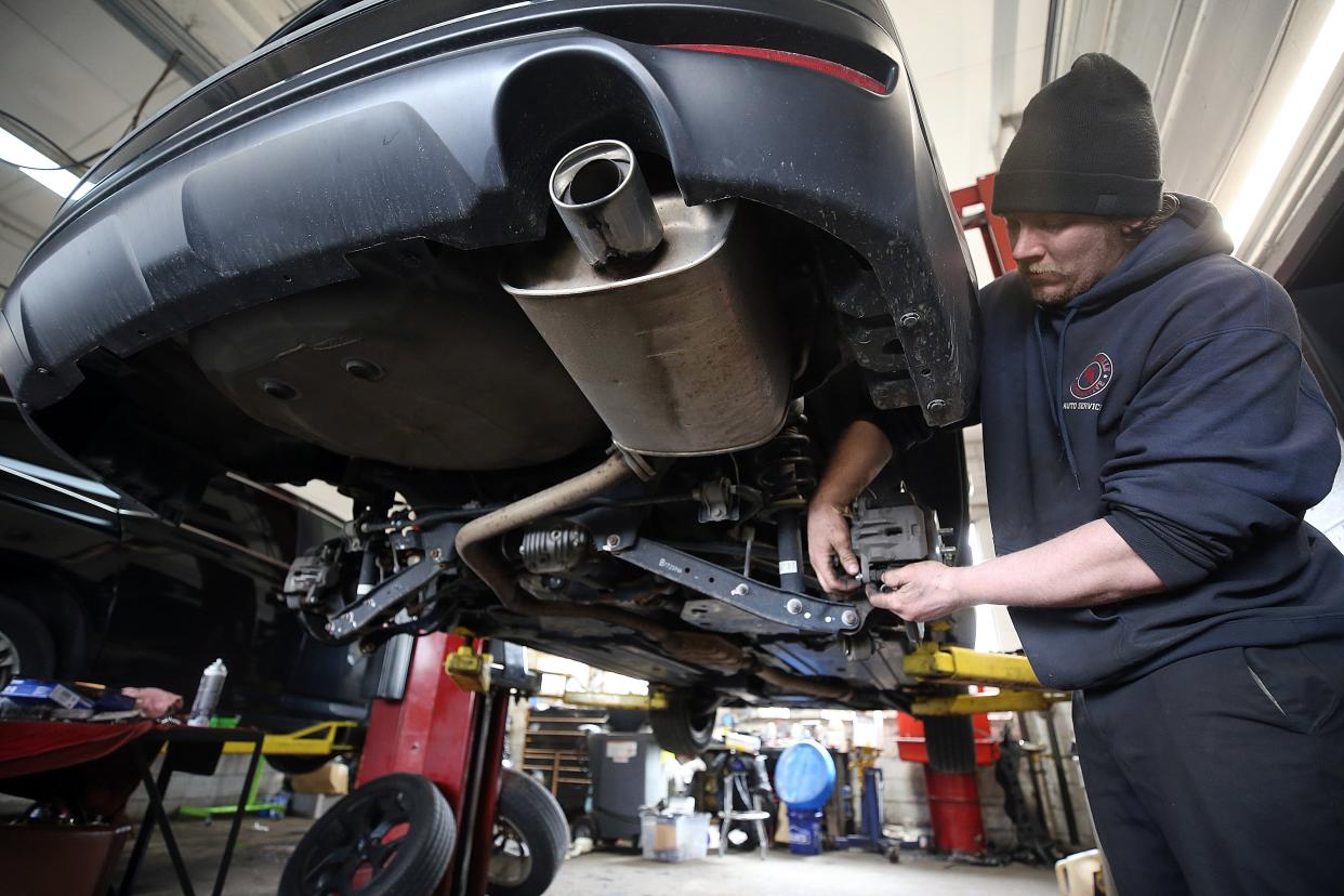 Zach Shipley, an auto technician at Westerville Automotive, 31 E. Main St., completes a brake job March 29.