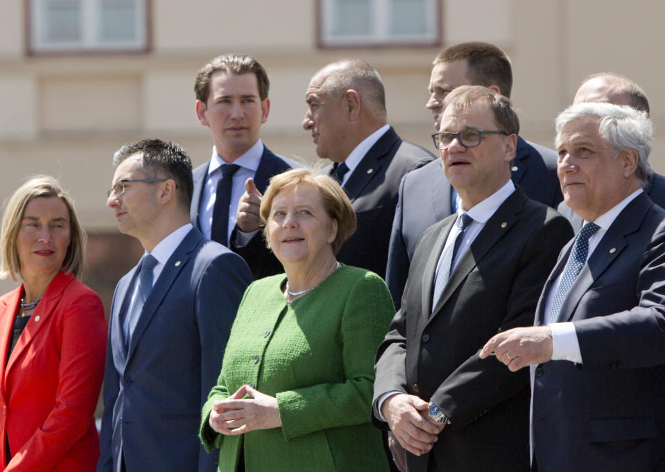 German Chancellor Angela Merkel, front center, poses with other EU leaders during a group photo at an EU summit in Sibiu, Romania, Thursday, May 9, 2019. European Union leaders on Thursday start to set out a course for increased political cooperation in the wake of the impending departure of the United Kingdom from the bloc. Front row left to right, European Union foreign policy chief Federica Mogherini, Slovenian Prime Minister Marjan Sarec, Finnish Prime Minister Juha Sipila and European Parliament President Antonio Tajani. (AP Photo/Virginia Mayo)